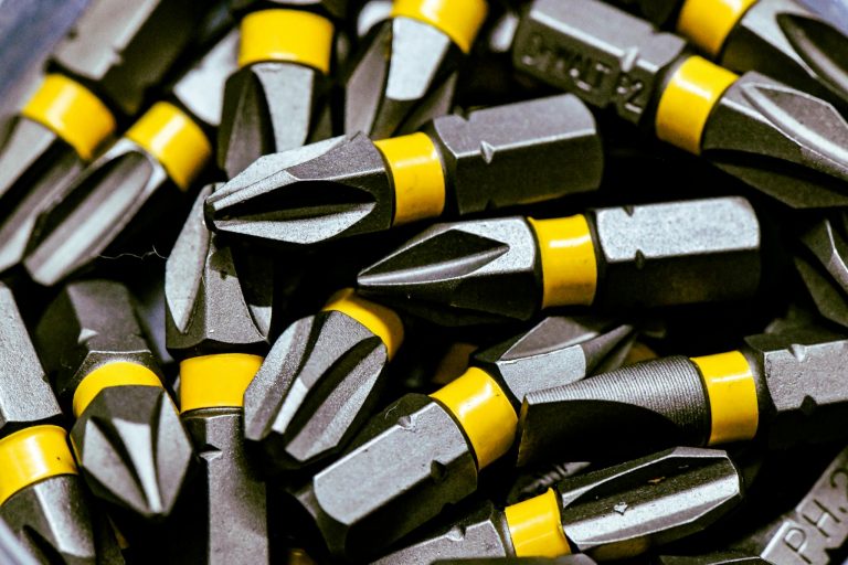 Detailed image of steel screwdriver bits with yellow bands.